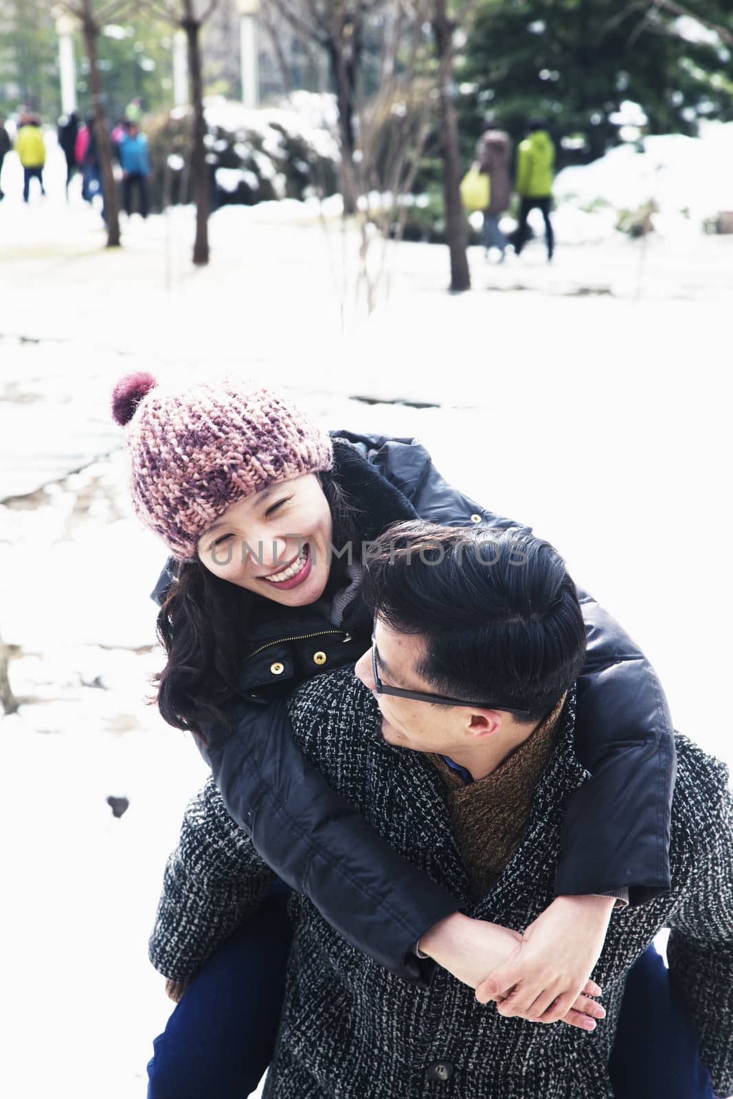 Smiling couple playing in the snow