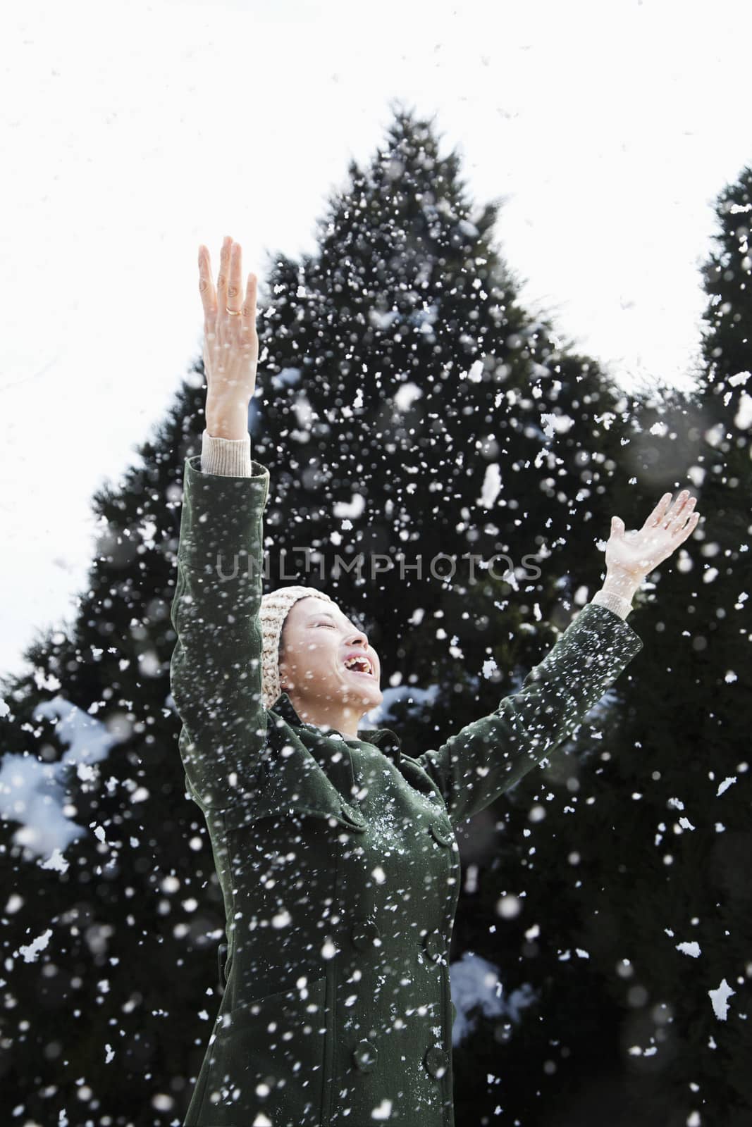 Woman with arms outstretched feeling the snow by XiXinXing