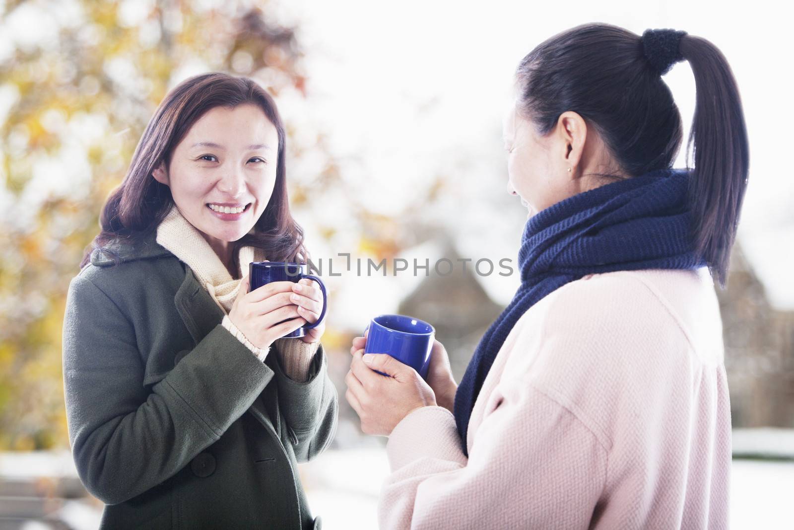 Two friends with hot beverages by XiXinXing