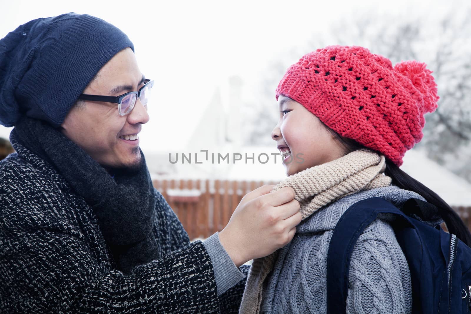 Father fixing daughter's scarf by XiXinXing