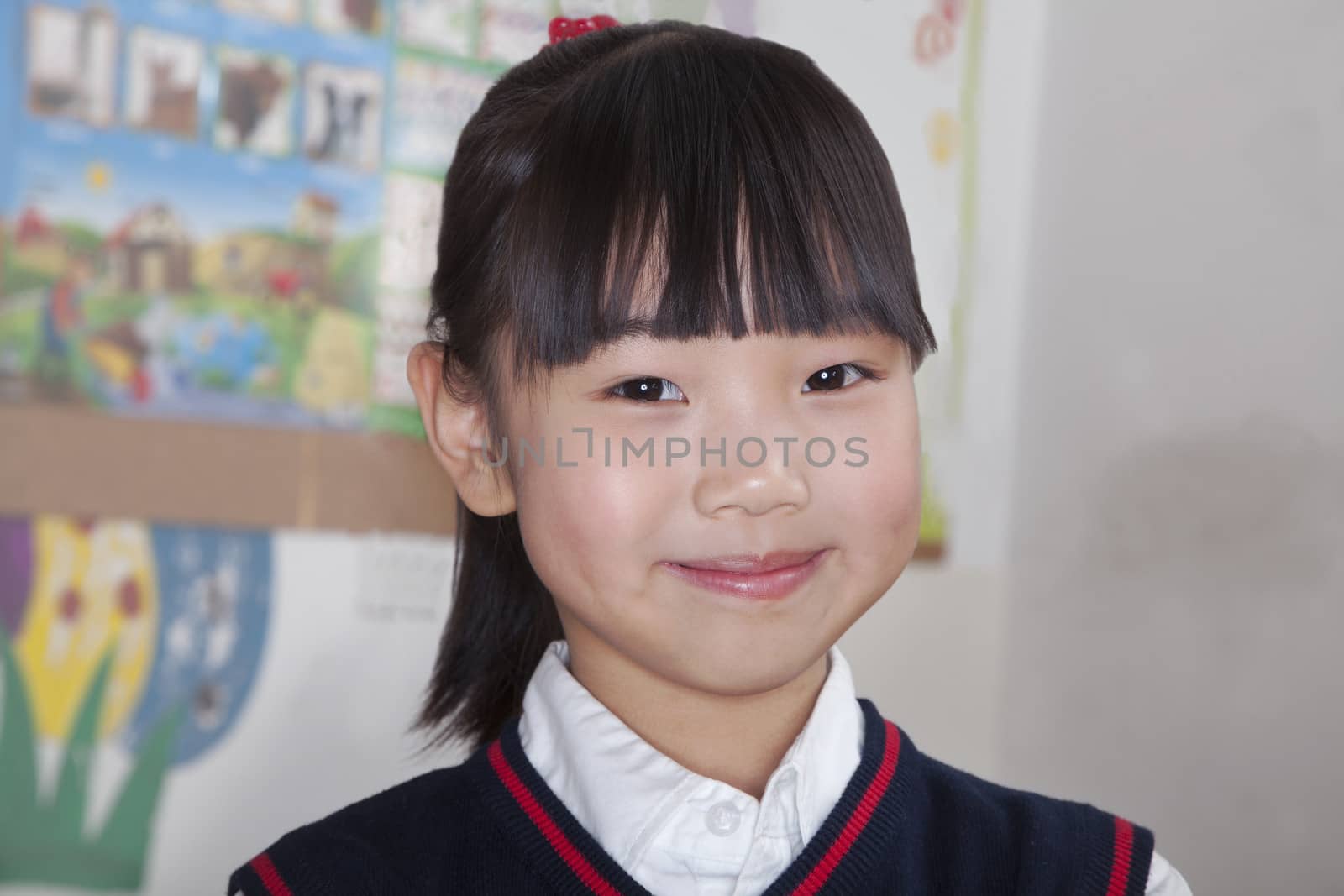 Portrait of schoolgirl in classroom, Beijing, China