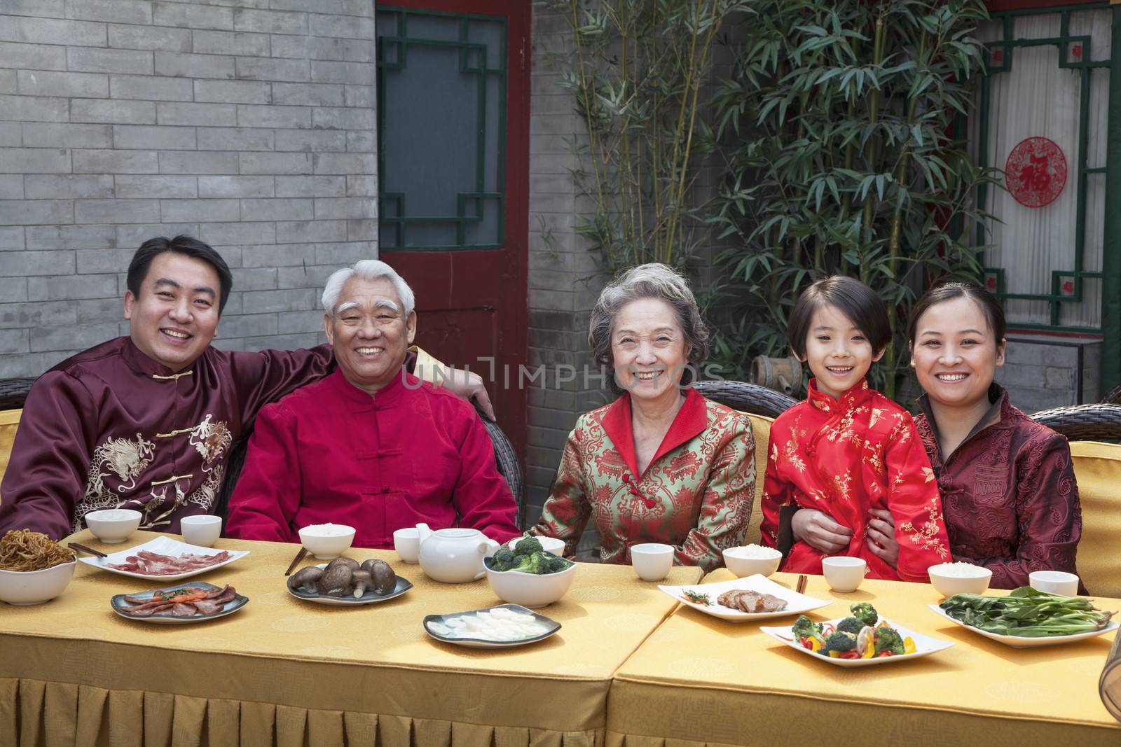 Portrait of family enjoying Chinese meal in traditional Chinese clothing by XiXinXing