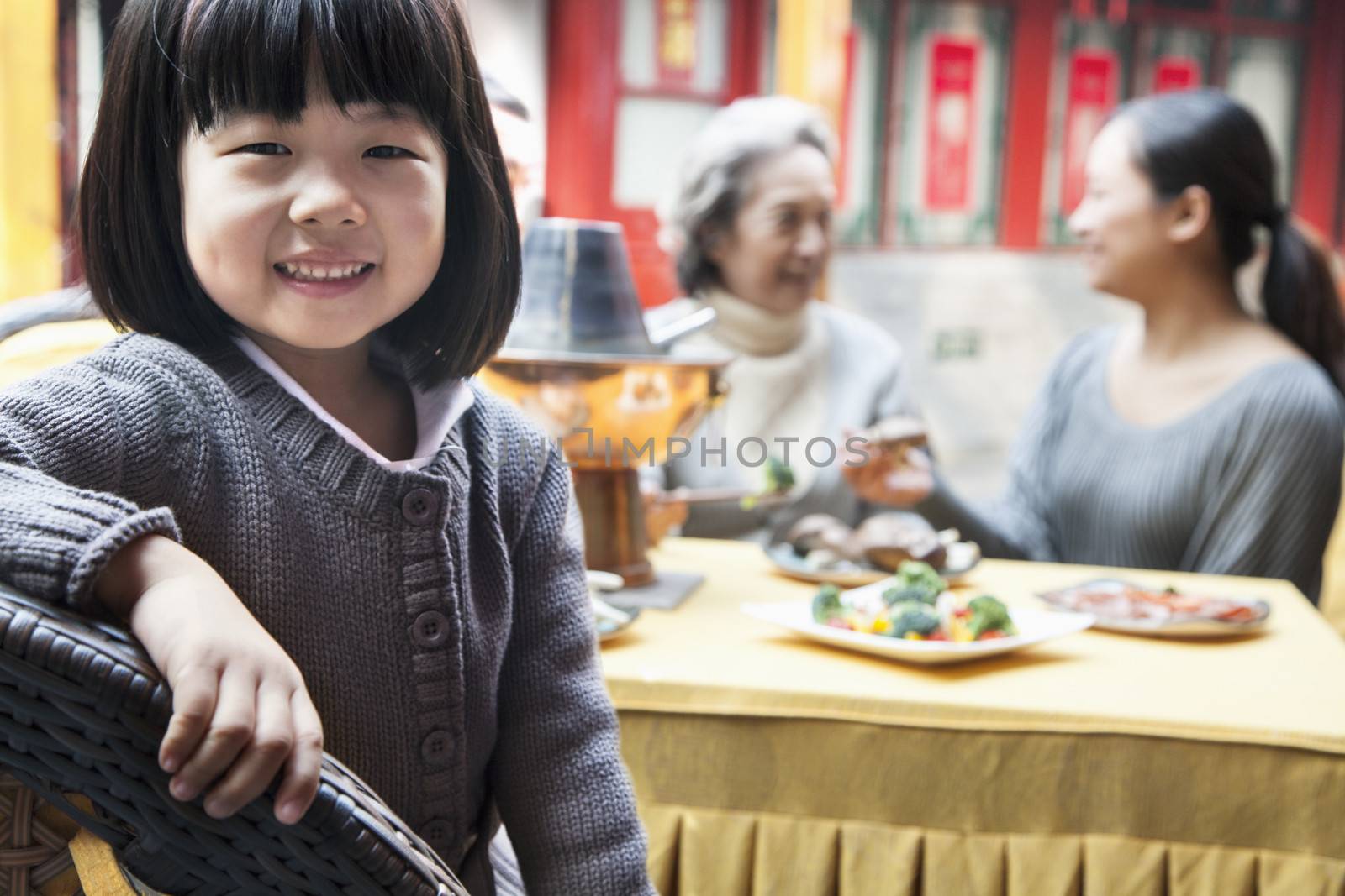 Portrait of young girl at family meal  by XiXinXing