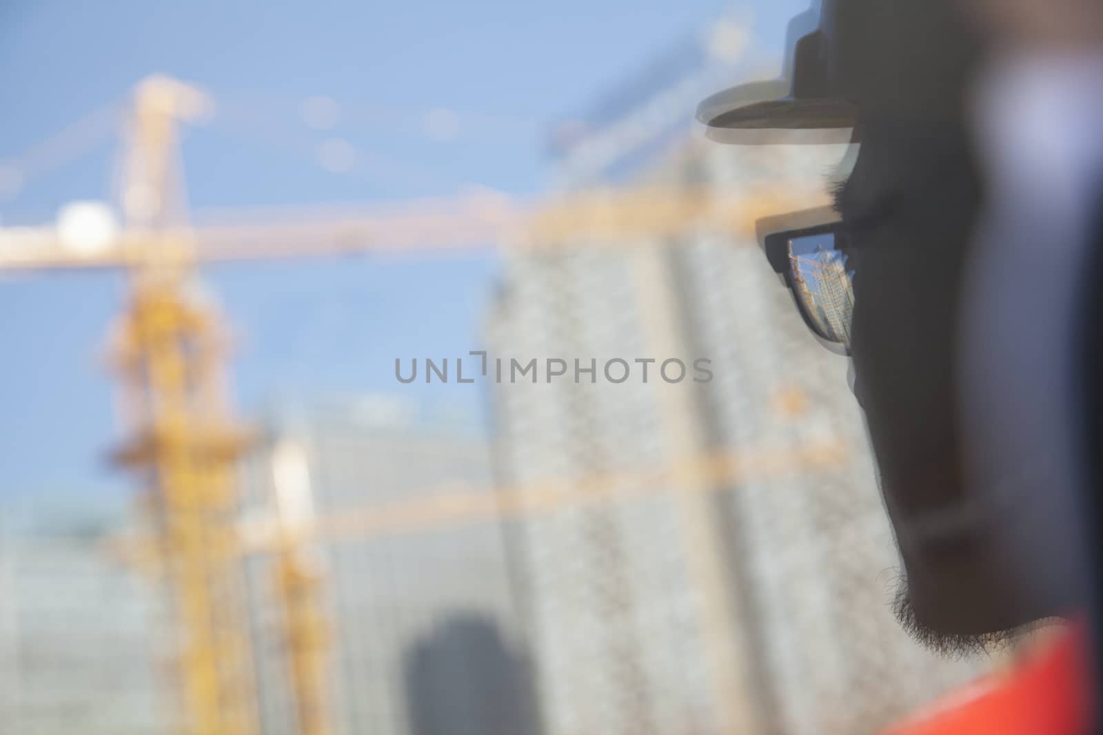 Close-up of reflection of architect on construction site   