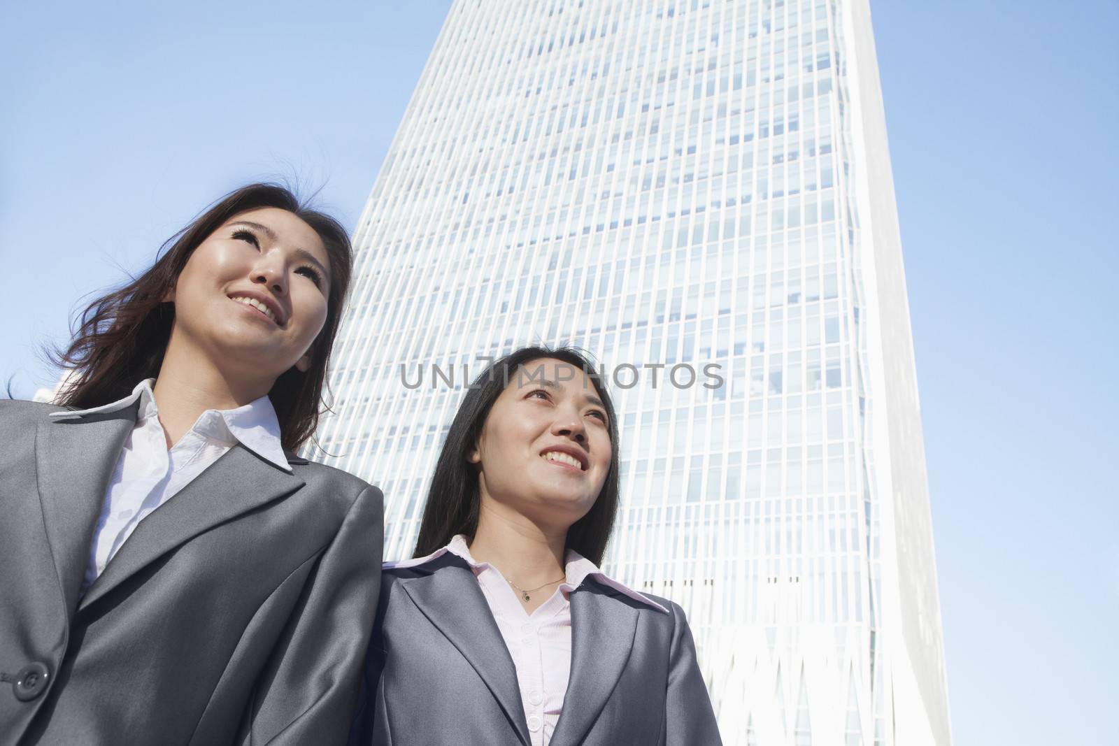Two businesswomen standing in front of Chinas world trade center in Beijing