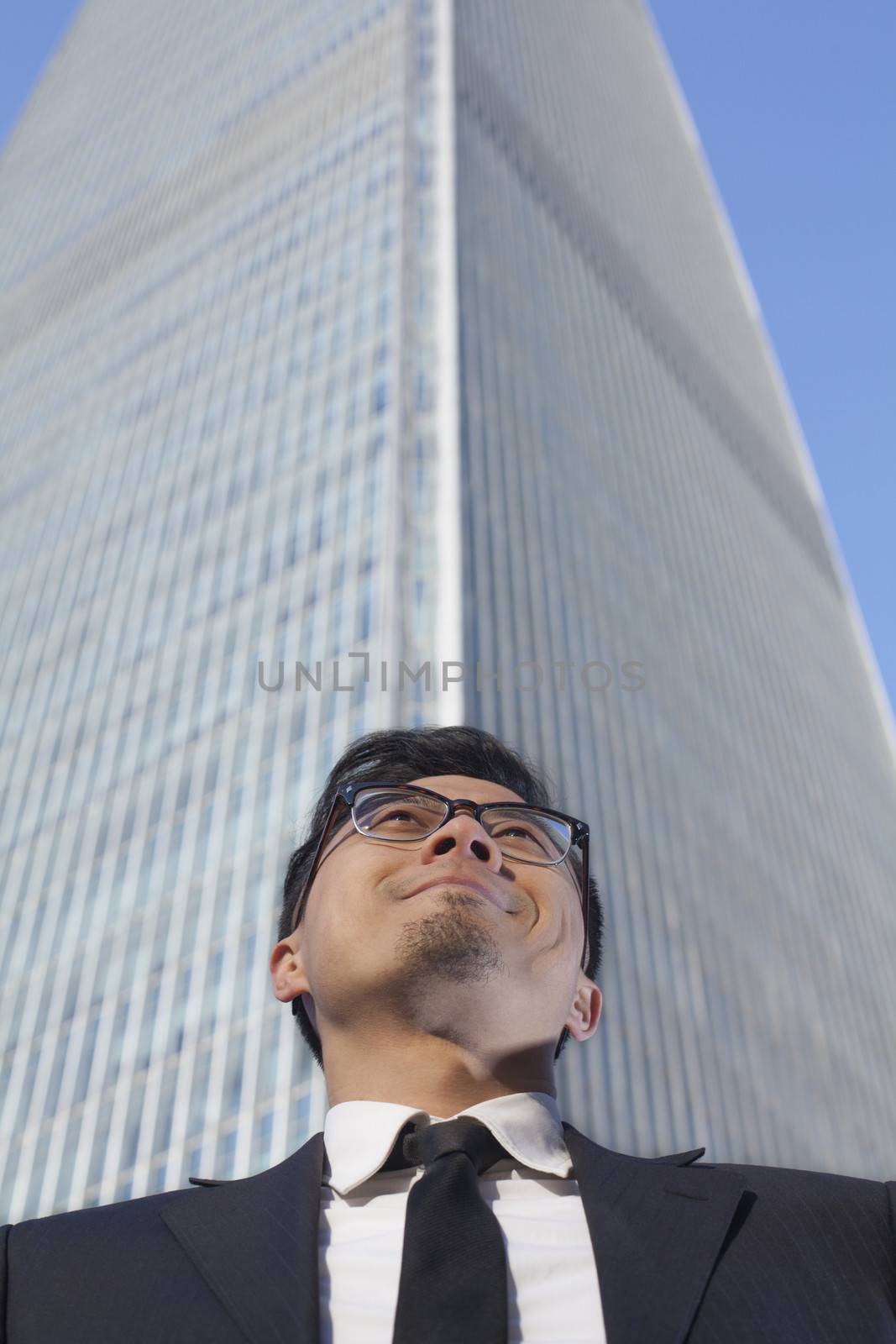 Businessman by the world trade center in Beijing, China by XiXinXing