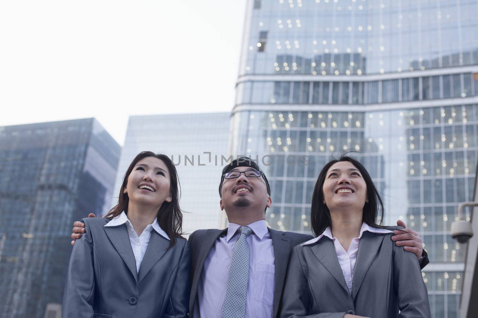 Portrait of smiling business people in a row outdoors, Beijing  