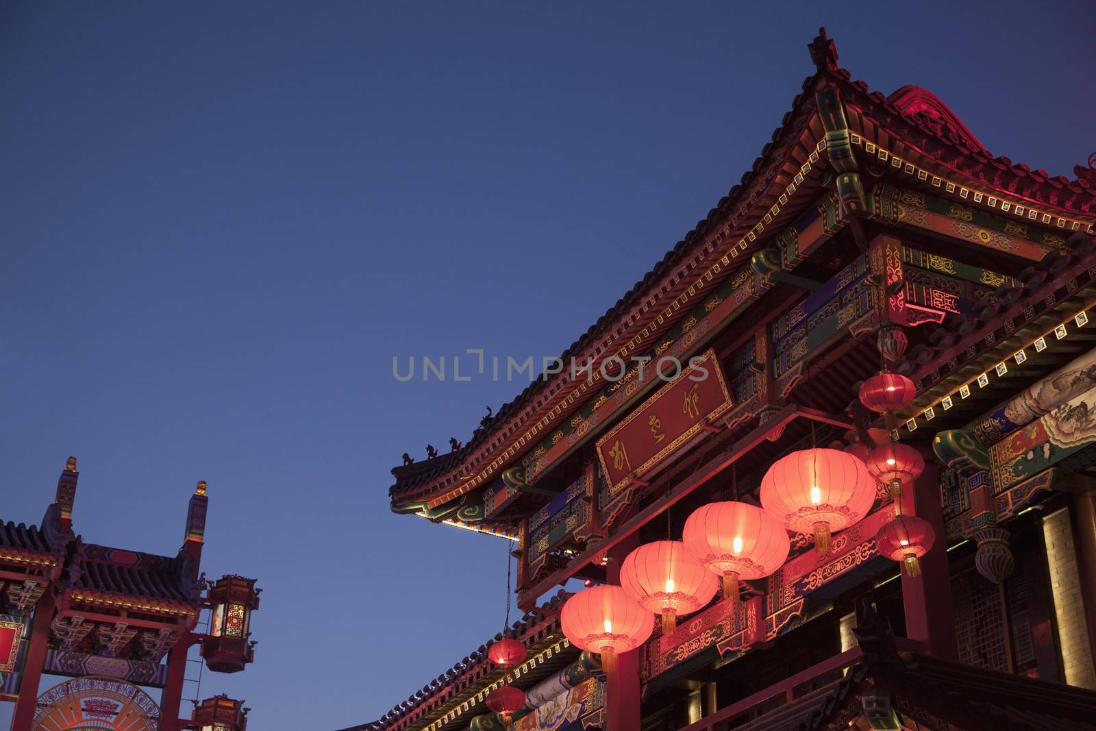 Traditional Chinese buildings illuminated at night in Beijing, China by XiXinXing