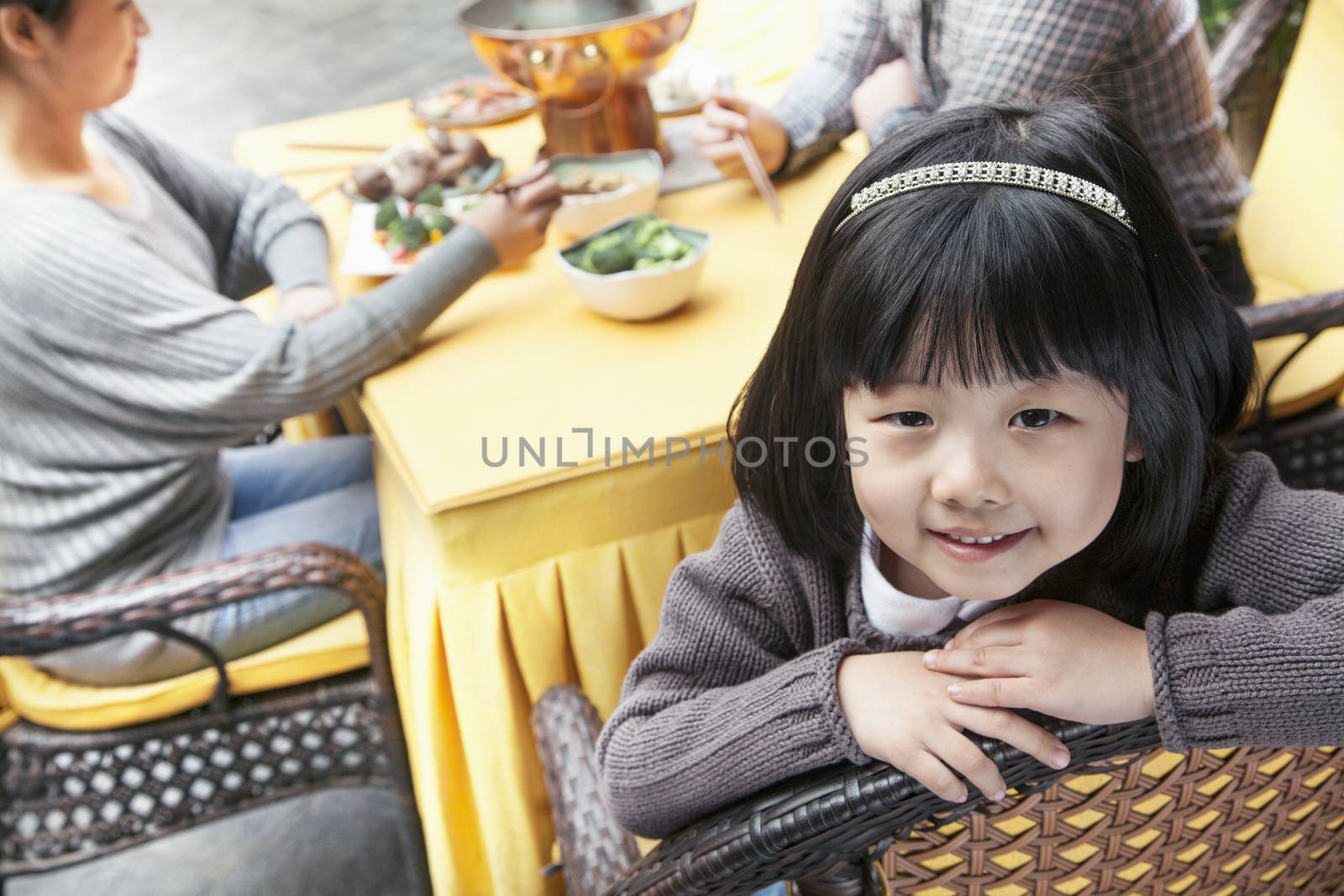 Portrait of little girl at family meal