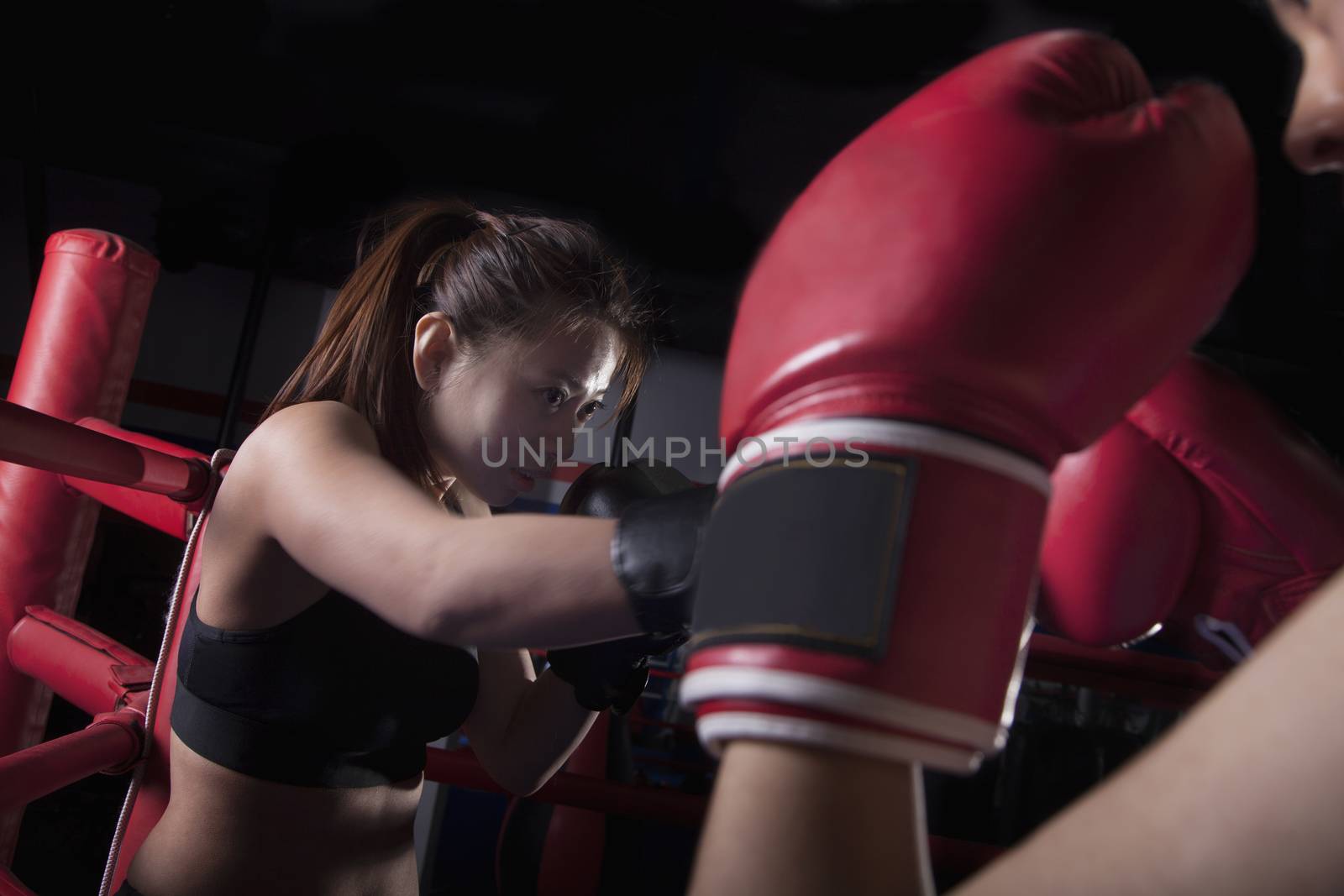 Over the shoulder view of two female boxers boxing in the boxing ring in Beijing, China