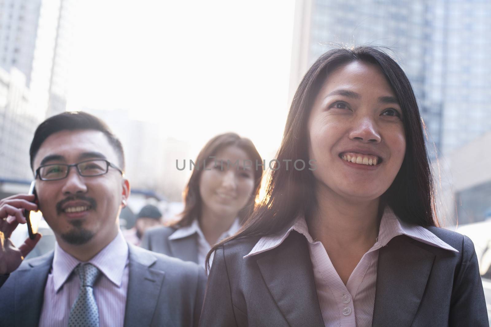 Portrait of smiling business people outdoors, Beijing  by XiXinXing