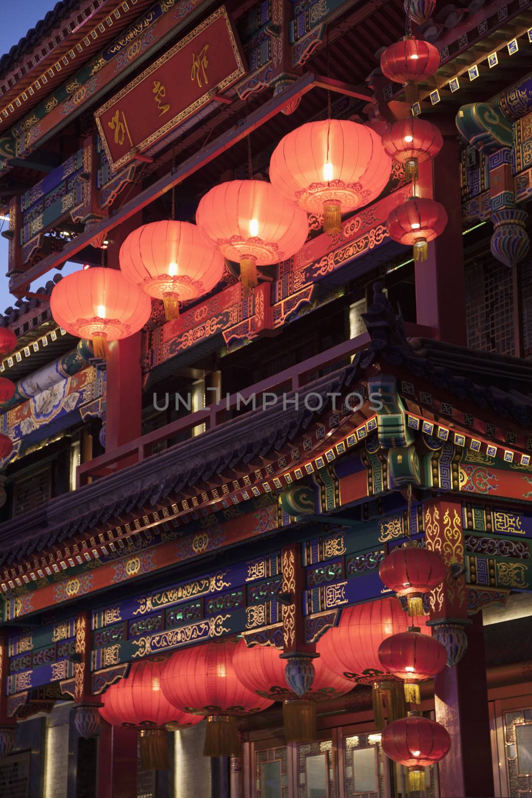 Traditional Chinese building illuminated at dusk in Beijing, China