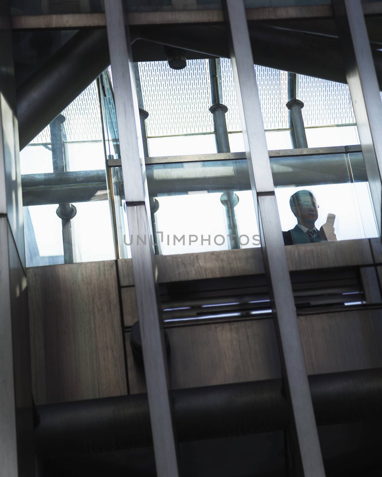 Businessman on the phone inside a modern building, silhouette   by XiXinXing