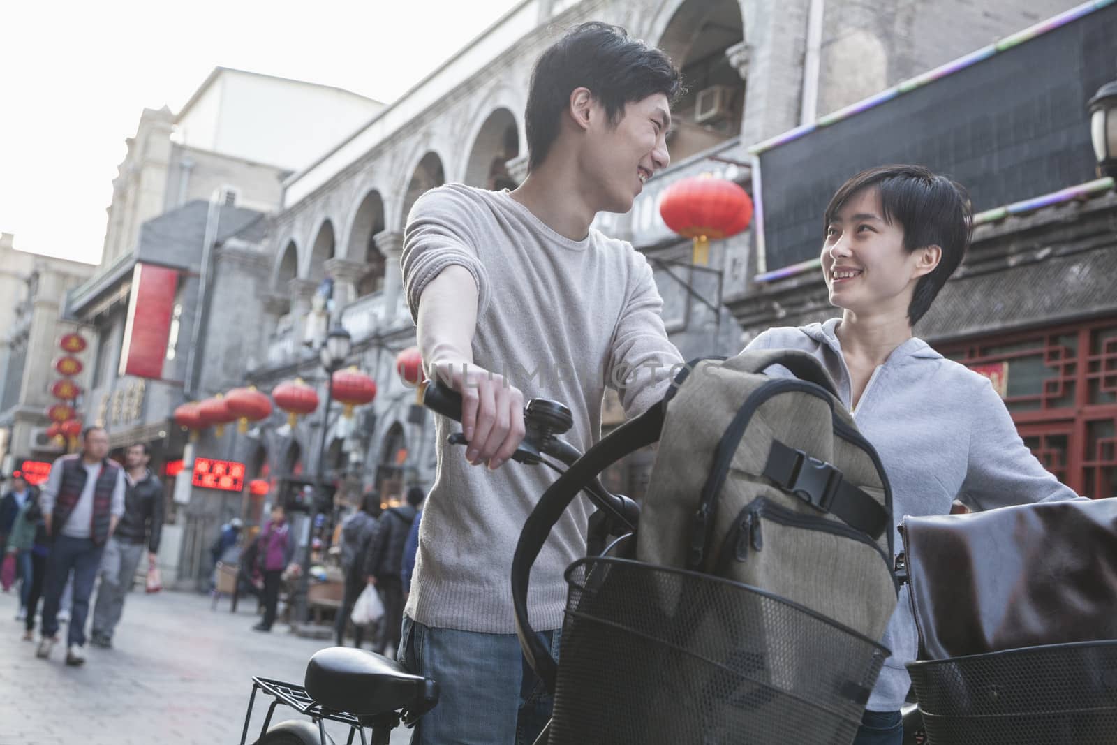 Young man and woman with bicycles and backpacks. by XiXinXing