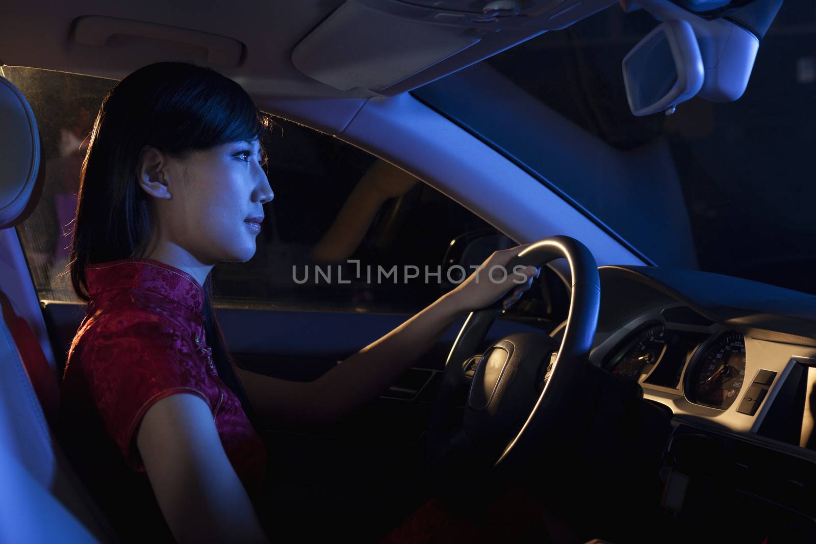 Young beautiful woman in a traditional Chinese dress driving at night   by XiXinXing