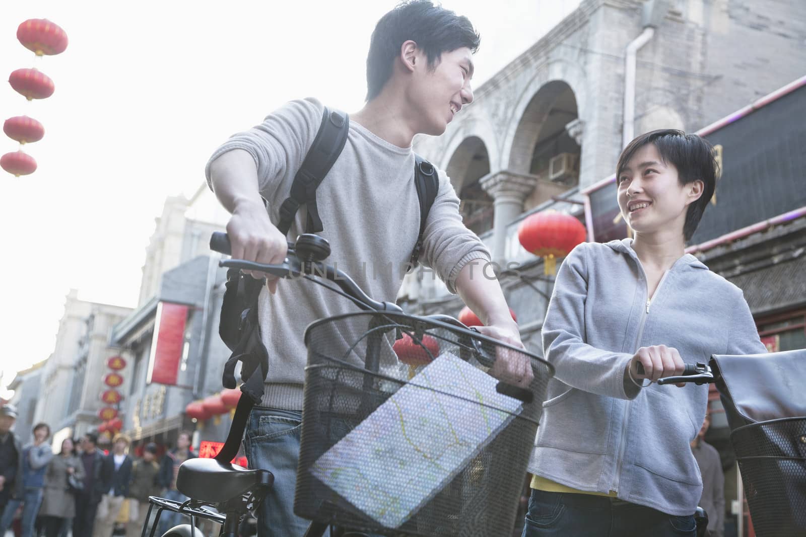 Young man and woman with bicycles and map.