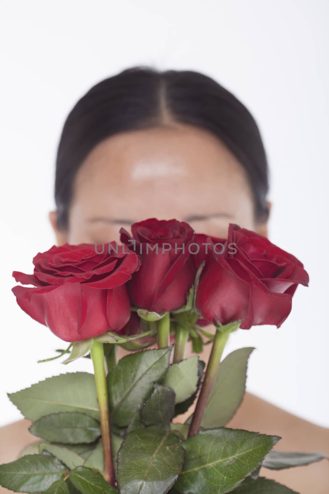 Shirtless woman behind a bunch of beautiful red roses, obscured face, studio shot by XiXinXing
