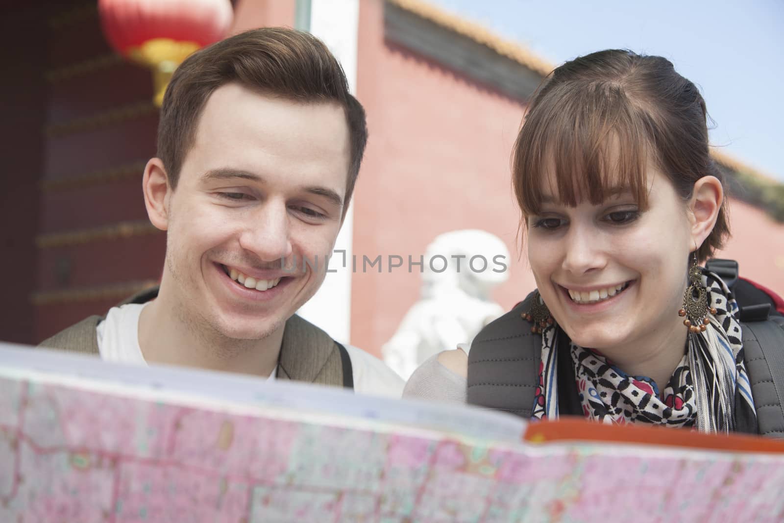 Young couple looking at map. 