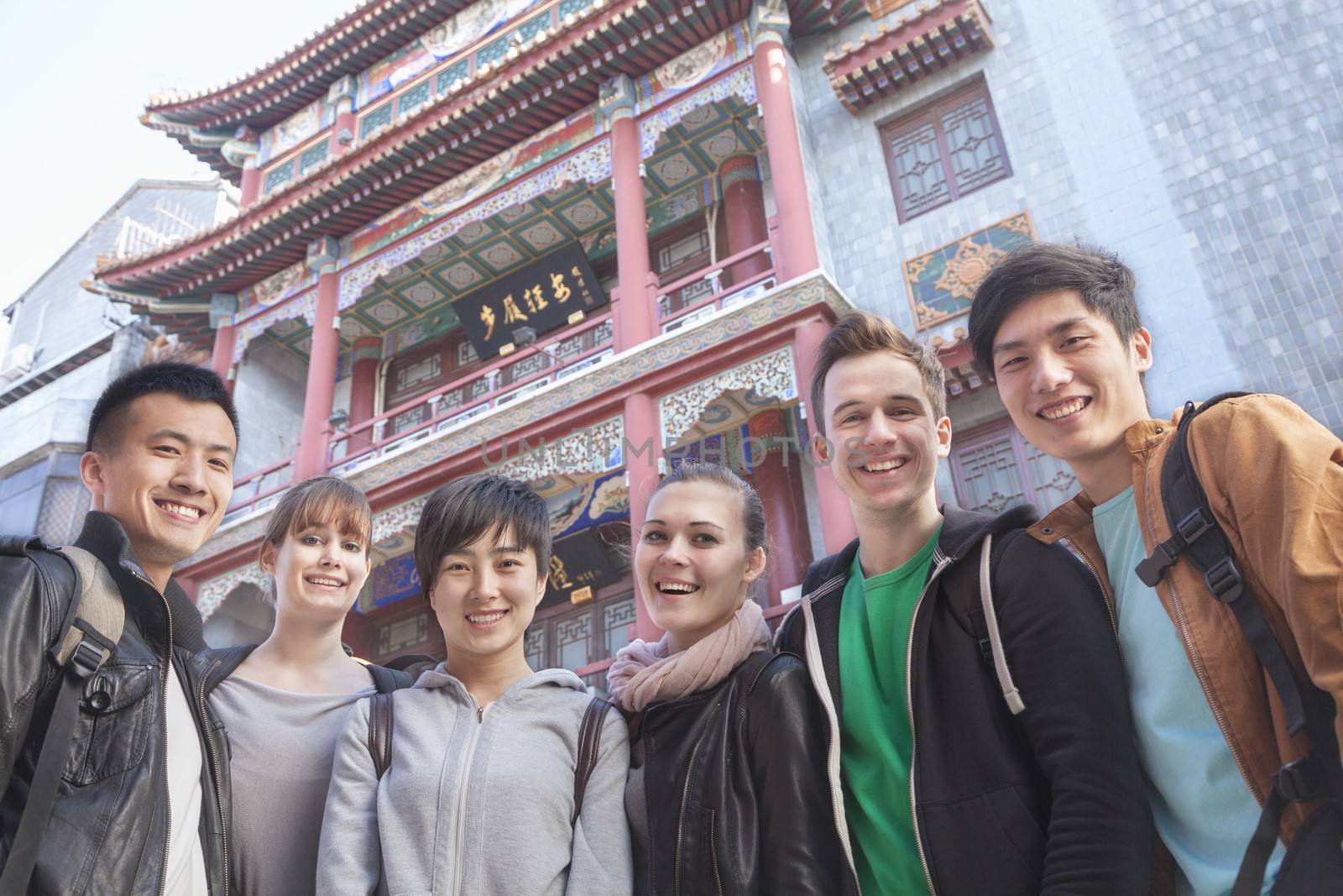 Group of young people with Chinese architecture in background, portrait. by XiXinXing