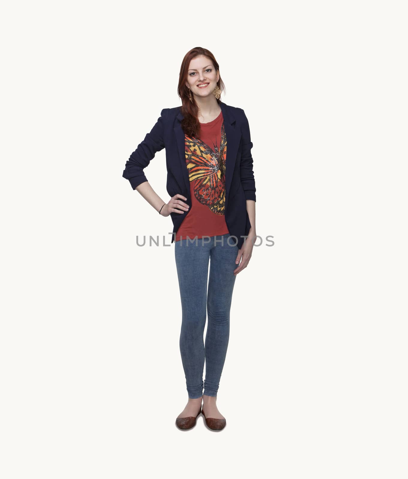 Portrait of smiling young woman in casual clothing, hand on hip, full length, studio shot