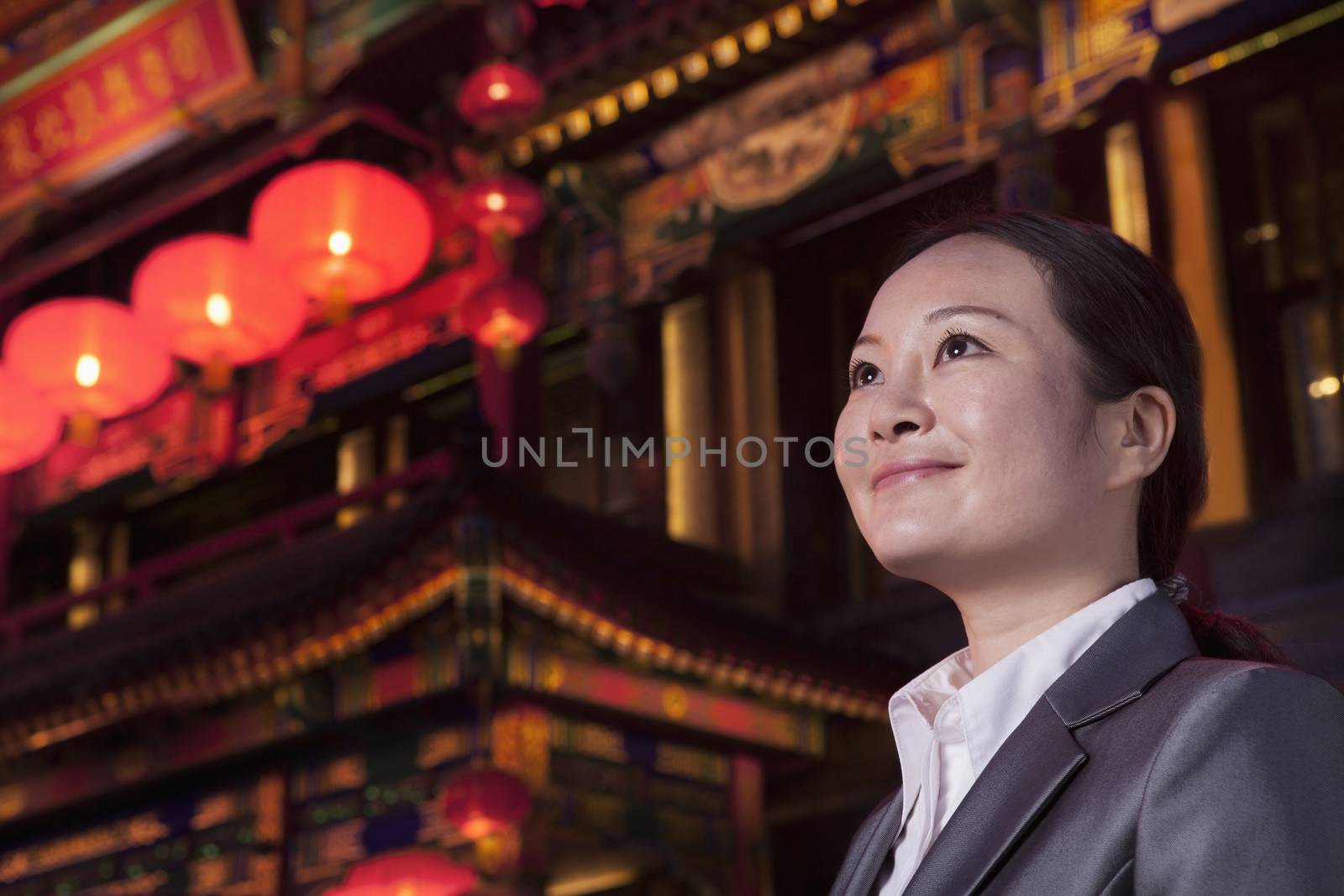 Businesswomen with Chinese architecture in background.