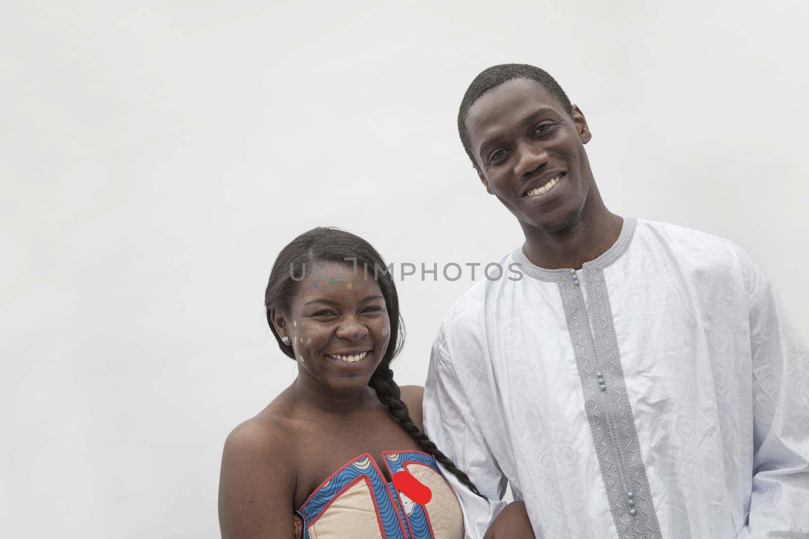 Portrait of young couple in traditional African clothing, studio shot   by XiXinXing