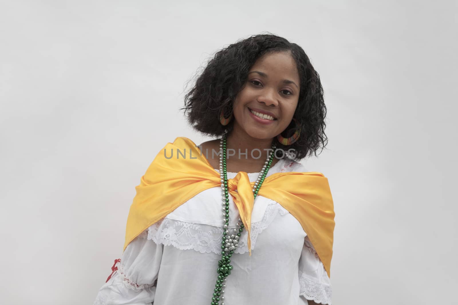 Portrait of smiling young woman wearing traditional clothing from the Caribbean, studio shot by XiXinXing