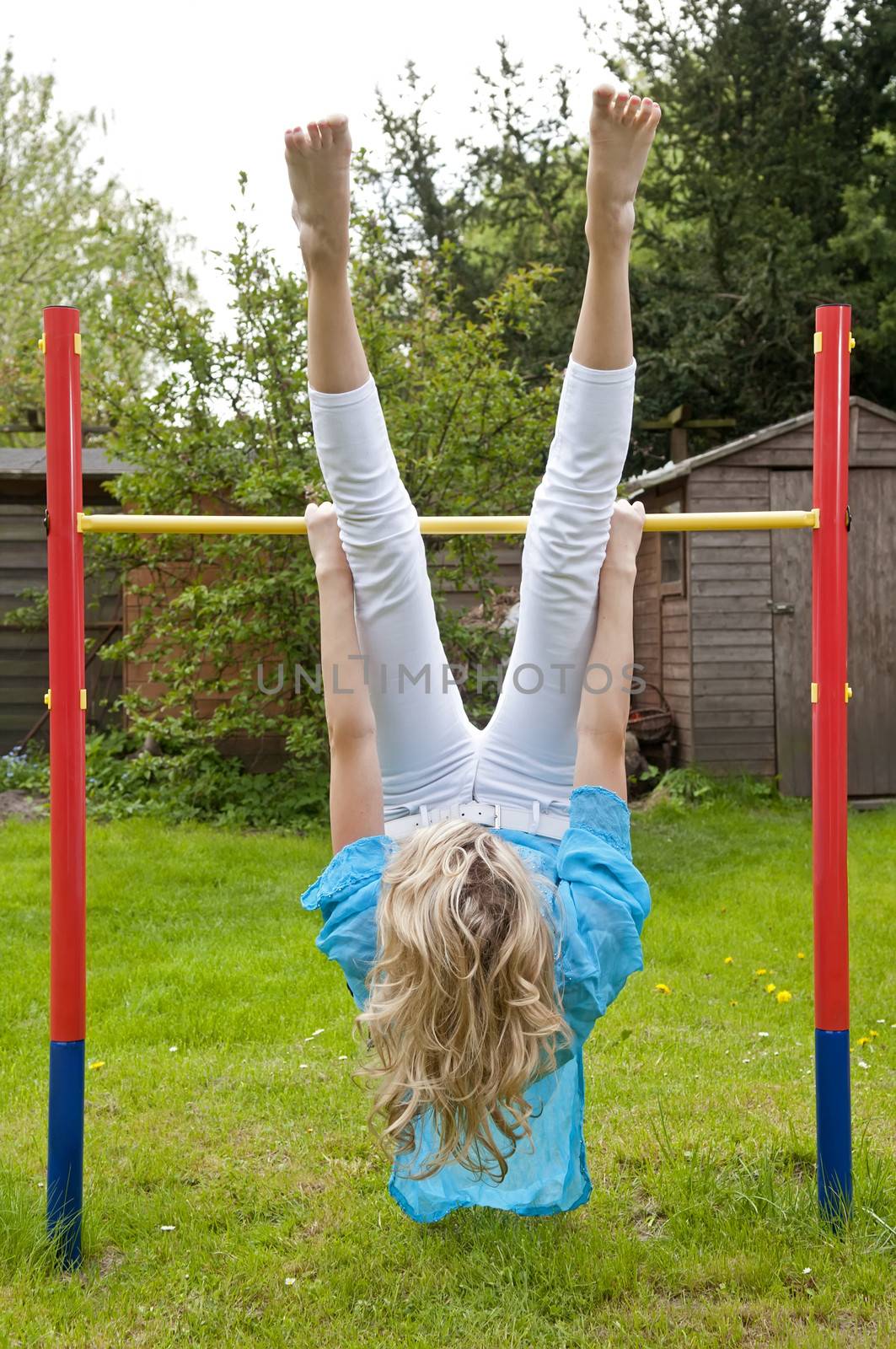 sporty young woman on the high bar