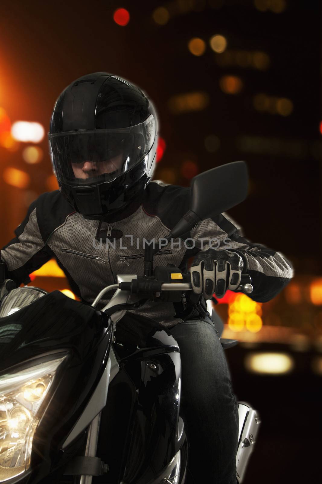 Young Man riding a motorcycle at night through the streets of Beijing by XiXinXing