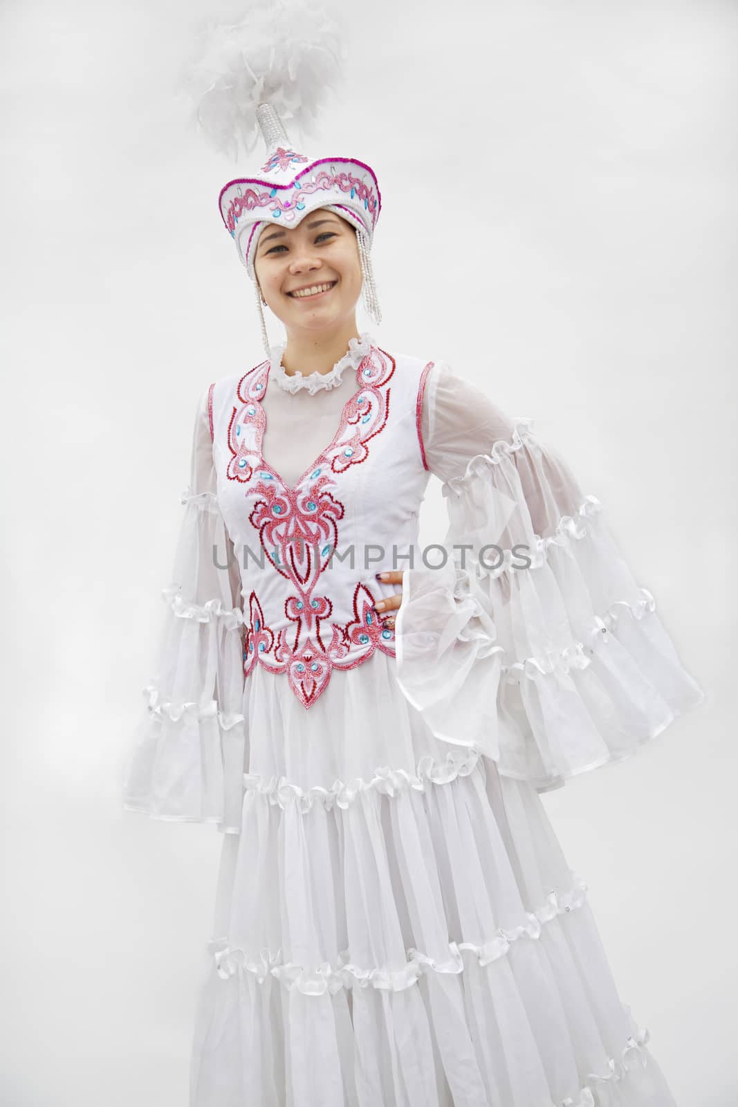 Portrait of young smiling woman in traditional clothing from Kazakhstan, studio shot by XiXinXing