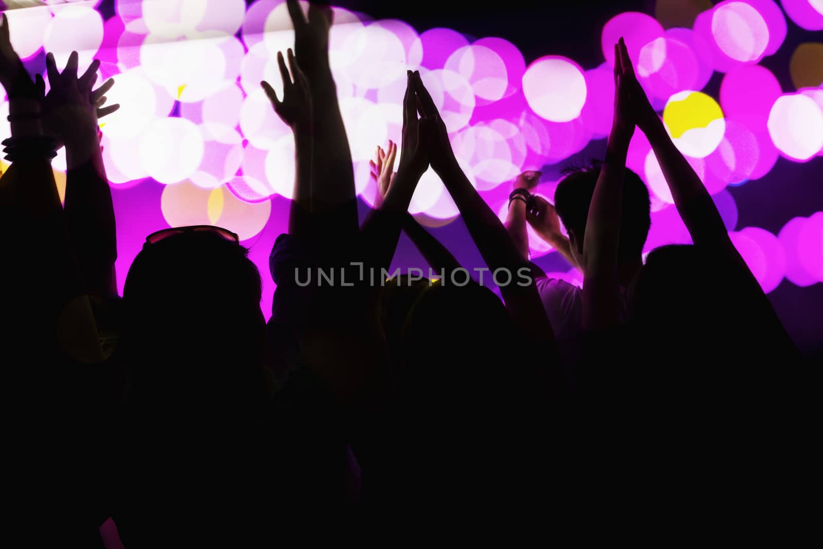 Audience watching a rock show, hands in the air, rear view, stage lights by XiXinXing