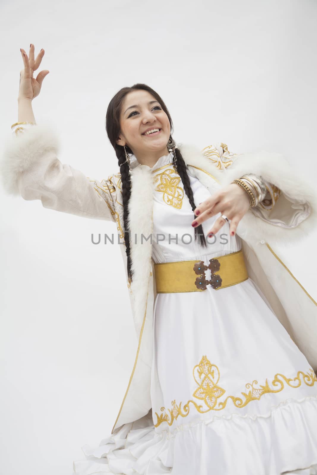 Portrait of young dancing woman with braids in traditional clothing from Kazakhstan, studio shot by XiXinXing