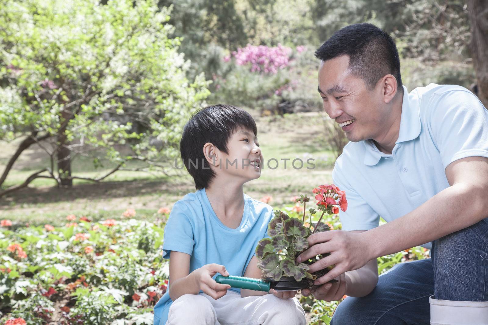 Father and son planting flowers. by XiXinXing