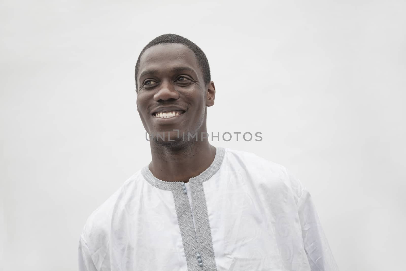 Portrait of young man in traditional African clothing, studio shot by XiXinXing