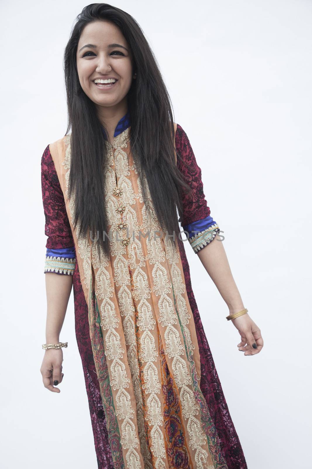 Portrait of smiling young woman wearing traditional clothing from Pakistan, studio shot