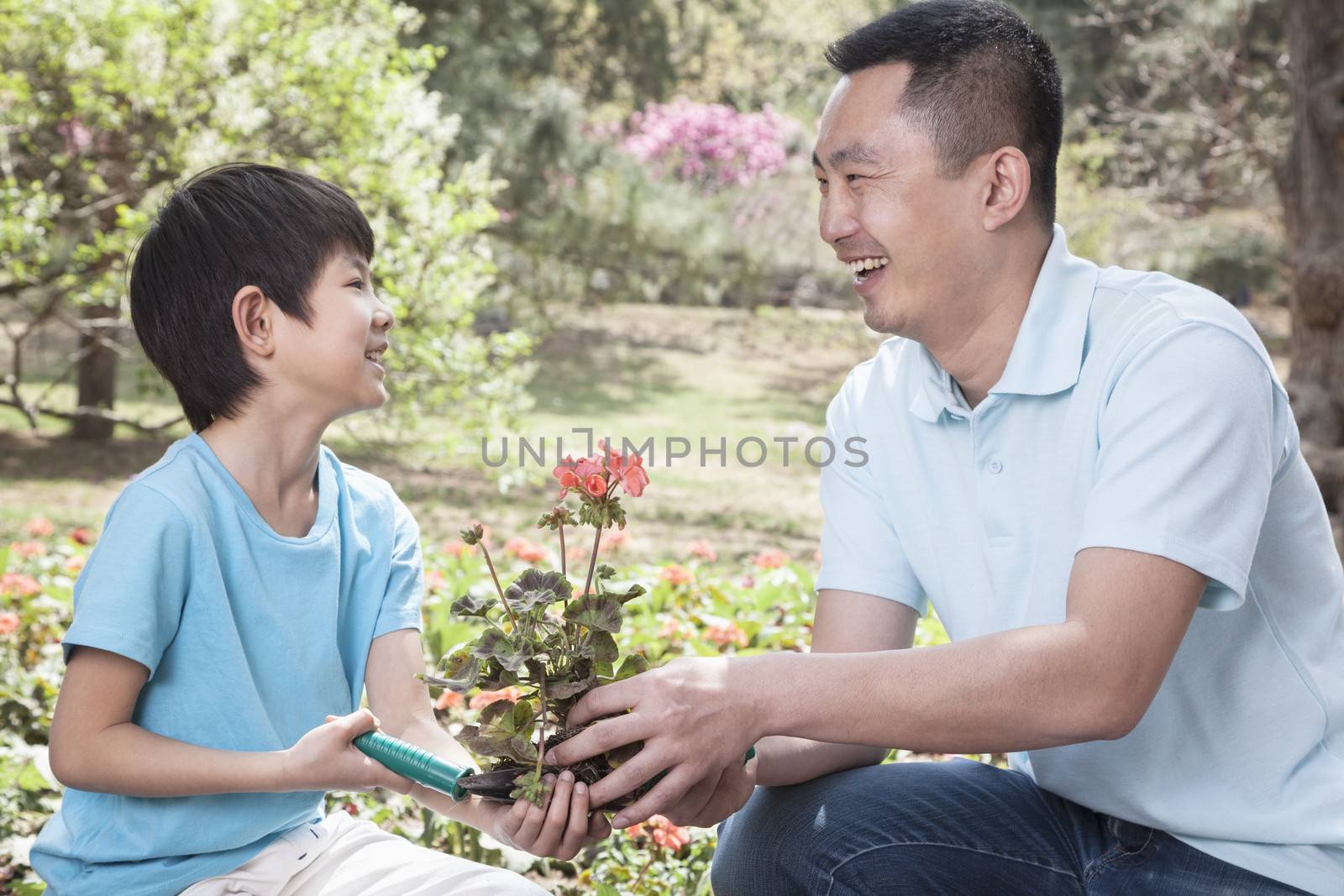 Father and son planting flowers. by XiXinXing