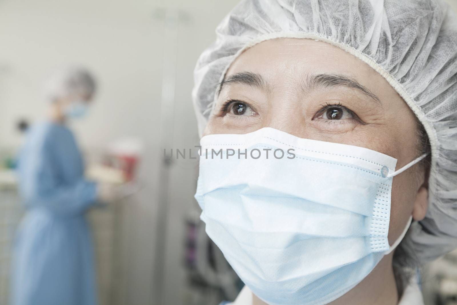 Portrait of surgeon with surgical mask and surgical cap in the operating room 