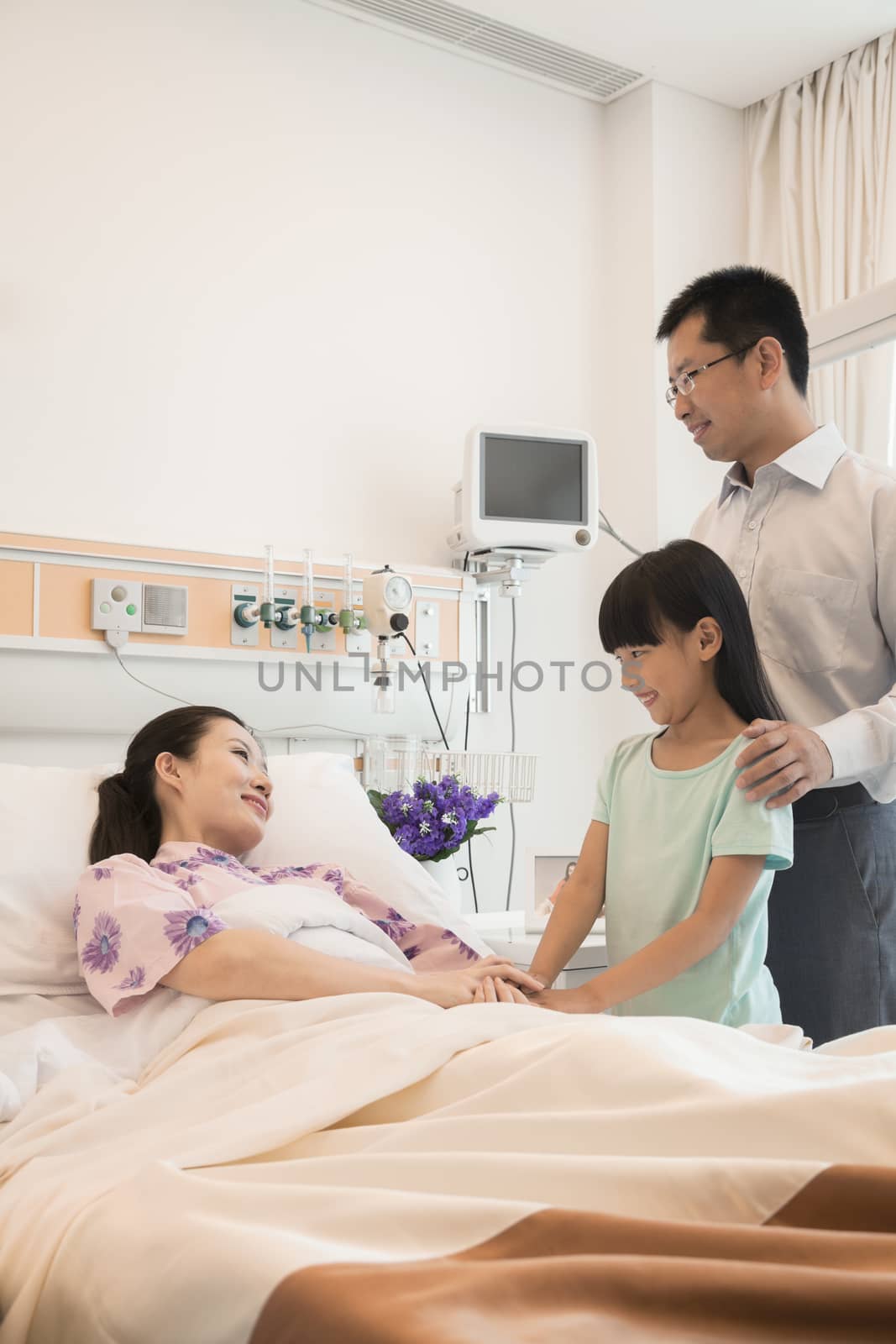 Family visiting the mother in the hospital, holding hands by XiXinXing