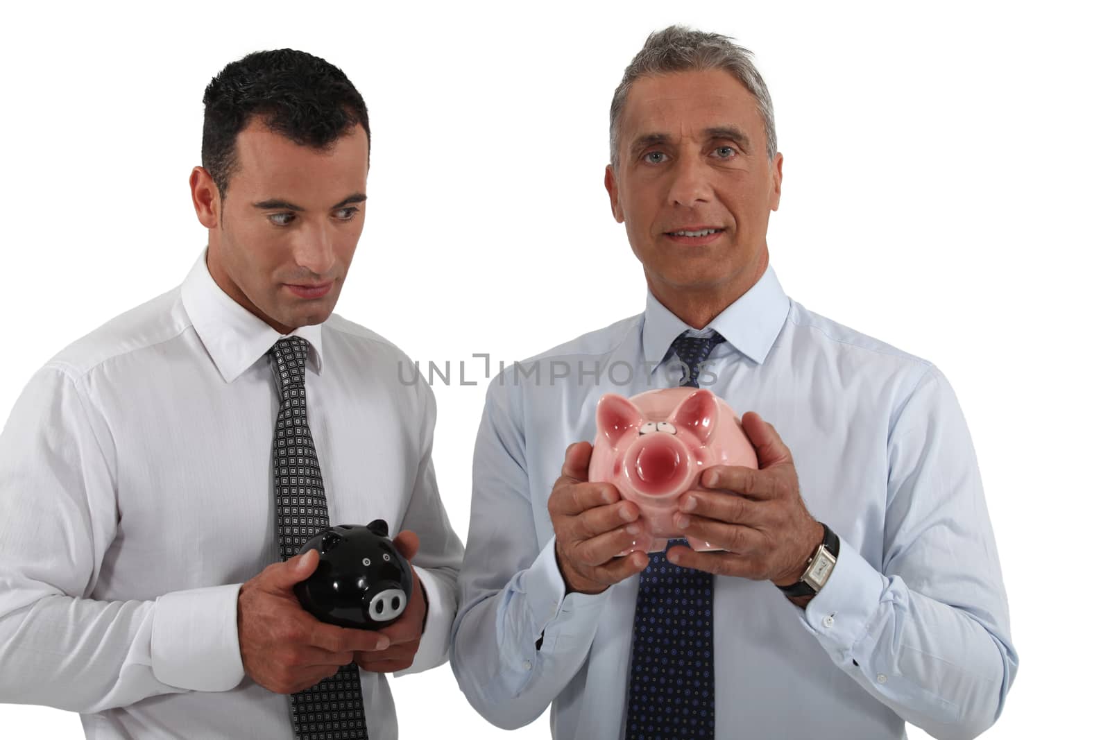 Two businessmen stood with piggy bank by phovoir