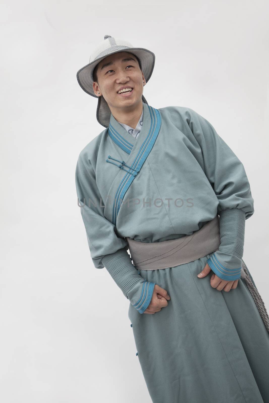 Portrait of smiling young man in traditional clothing, studio shot