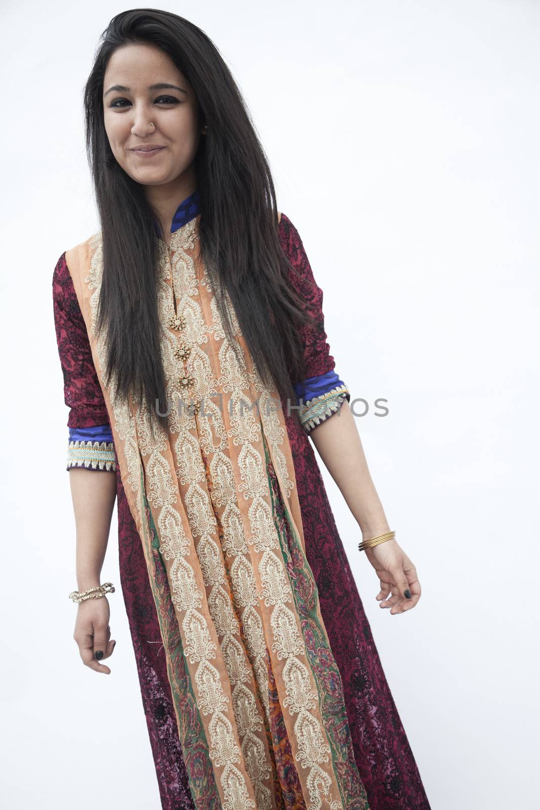 Portrait of smiling young woman wearing traditional clothing from Pakistan, studio shot