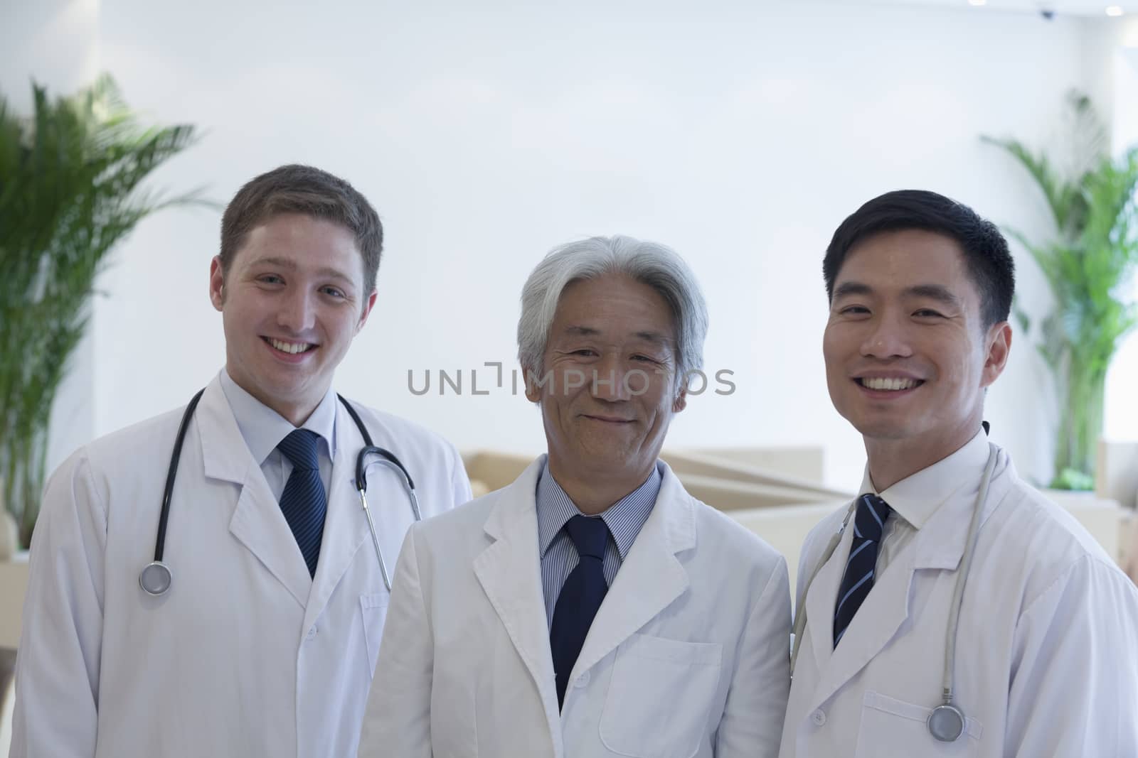 Portrait of three smiling doctors in the hospital, multi-ethnic group by XiXinXing