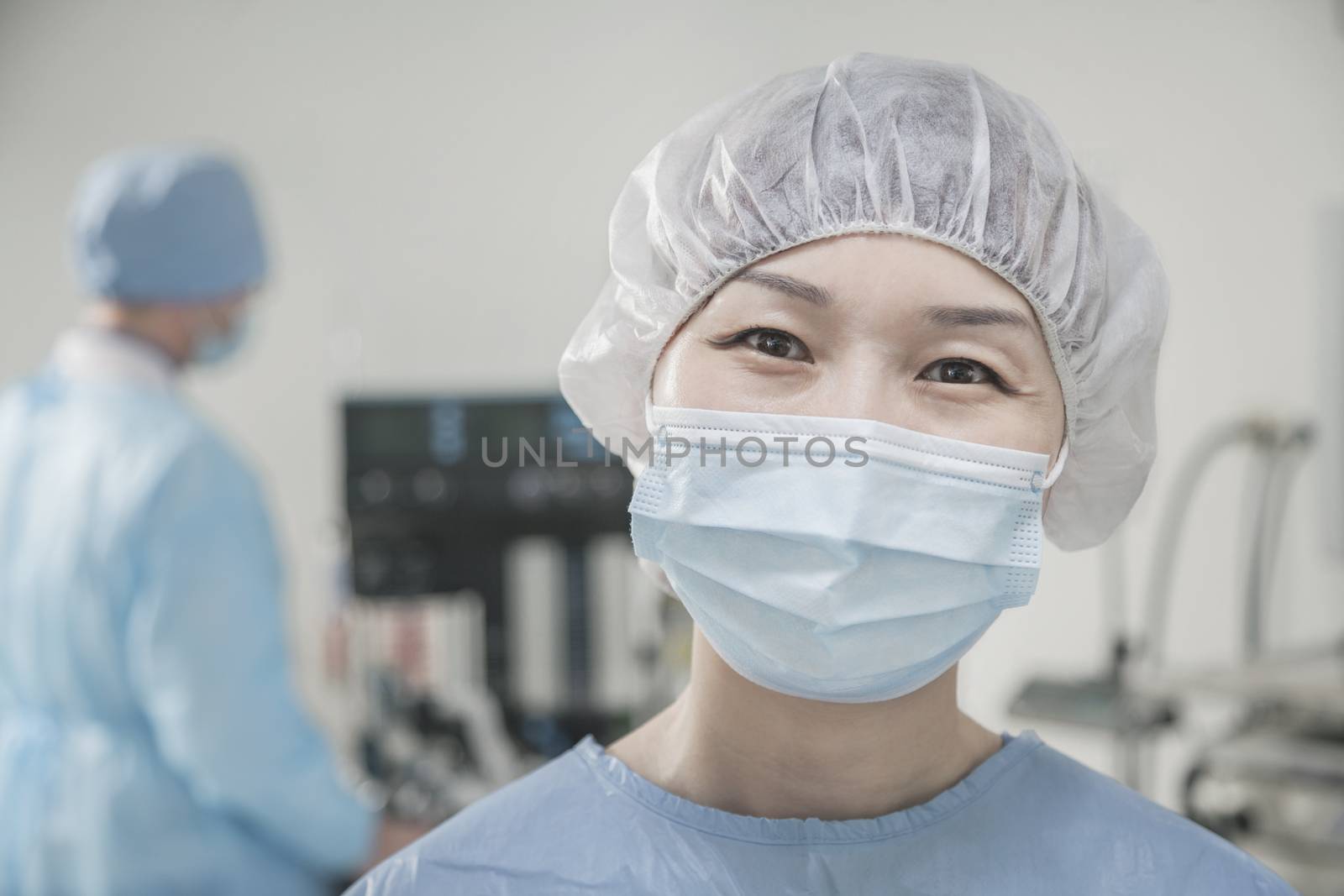 Portrait of surgeon with surgical mask and surgical cap in the operating room 