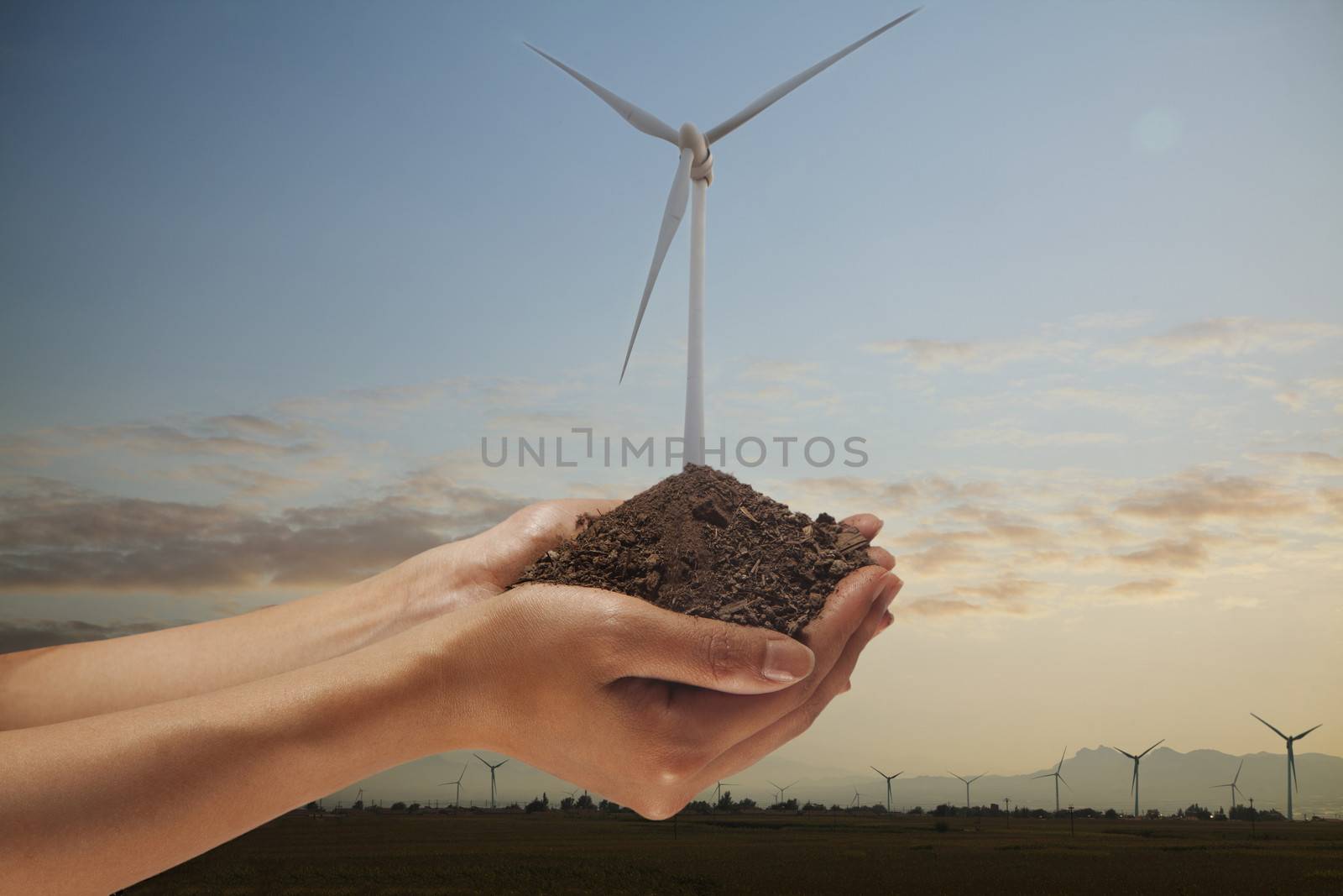 Hands holding soil with a wind turbine growing out from the middle by XiXinXing