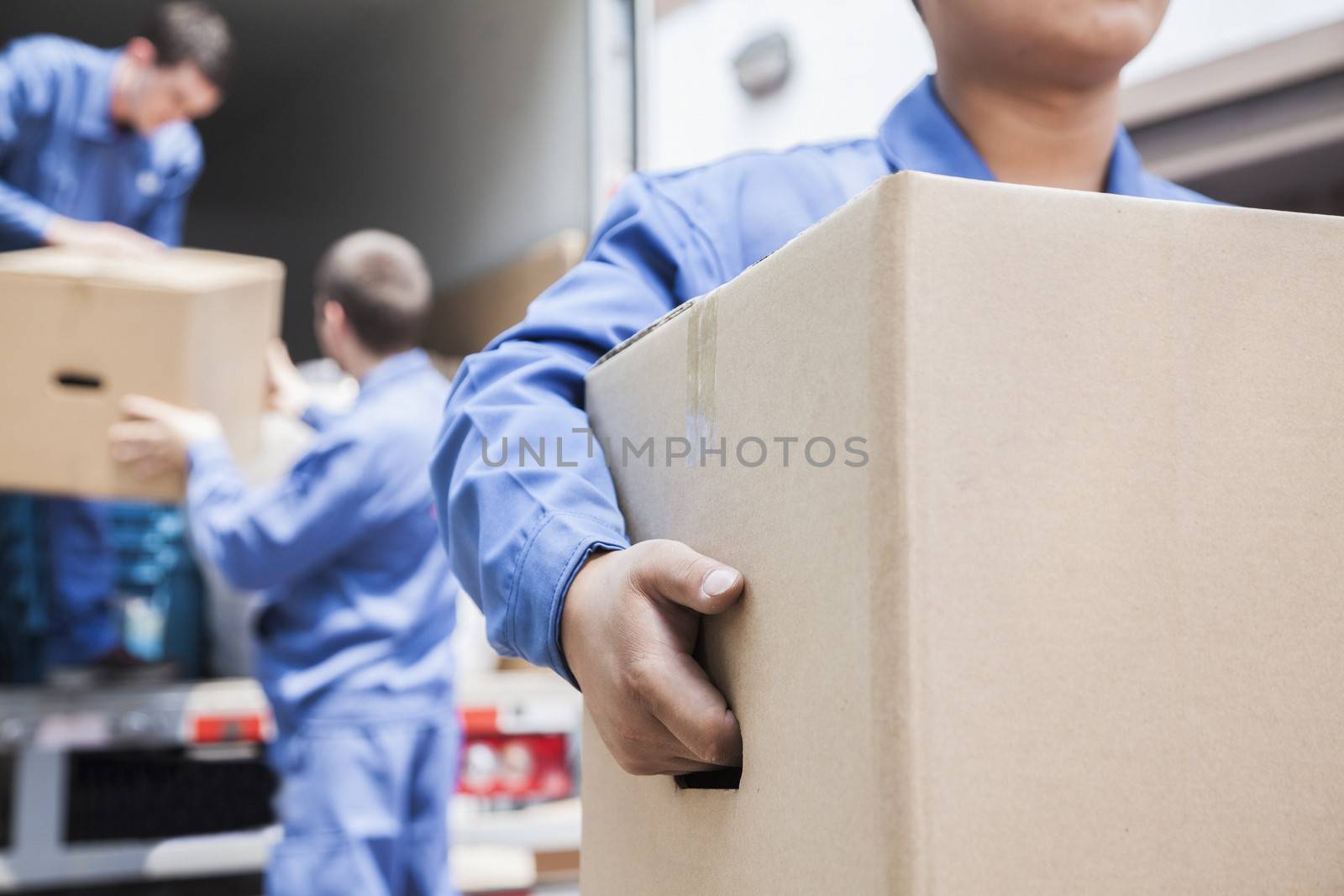 Movers unloading a moving van by XiXinXing