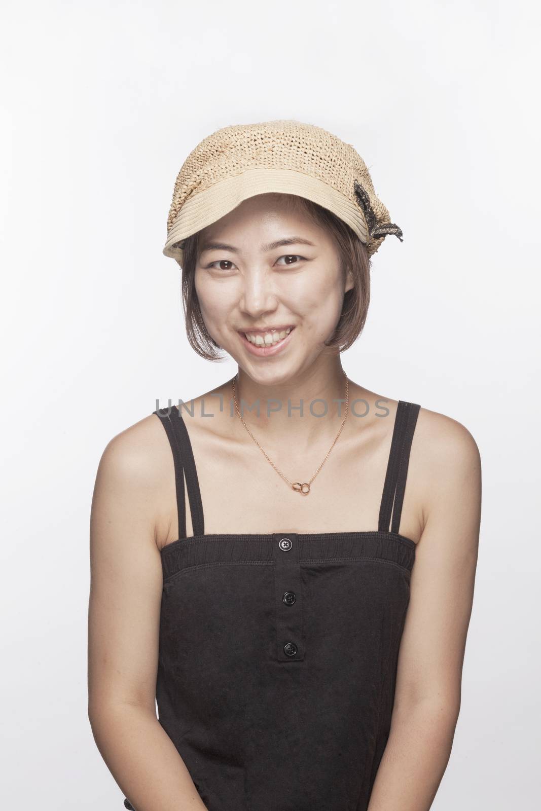 Portrait of smiling woman with hat, studio shot