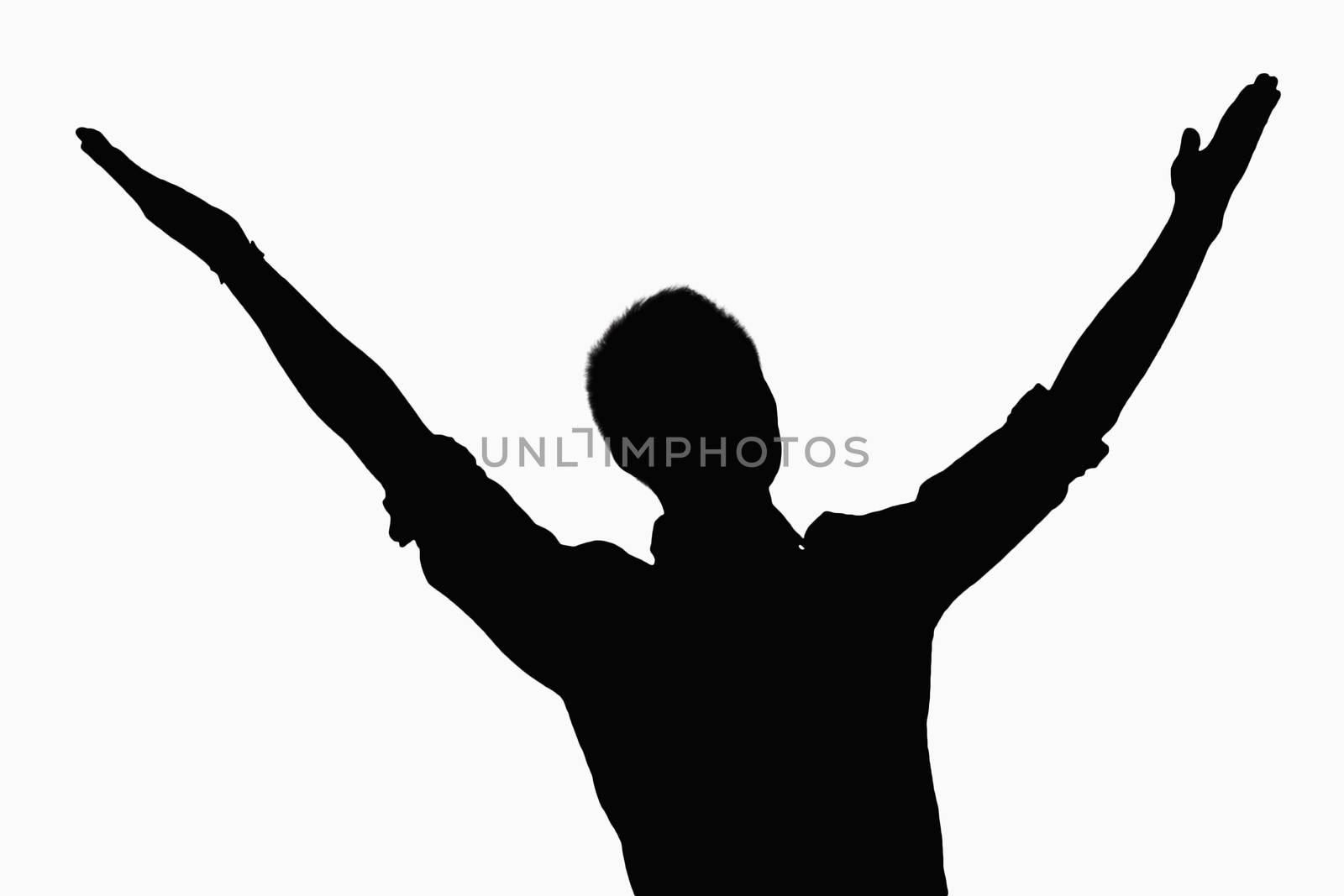 Silhouette of businessman with arms raised.