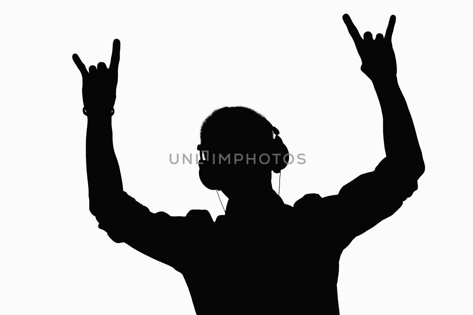 Silhouette of man listening to headphones. 