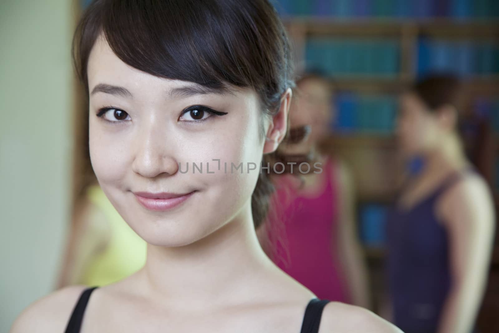 Portrait of smiling young woman in a yoga studio by XiXinXing