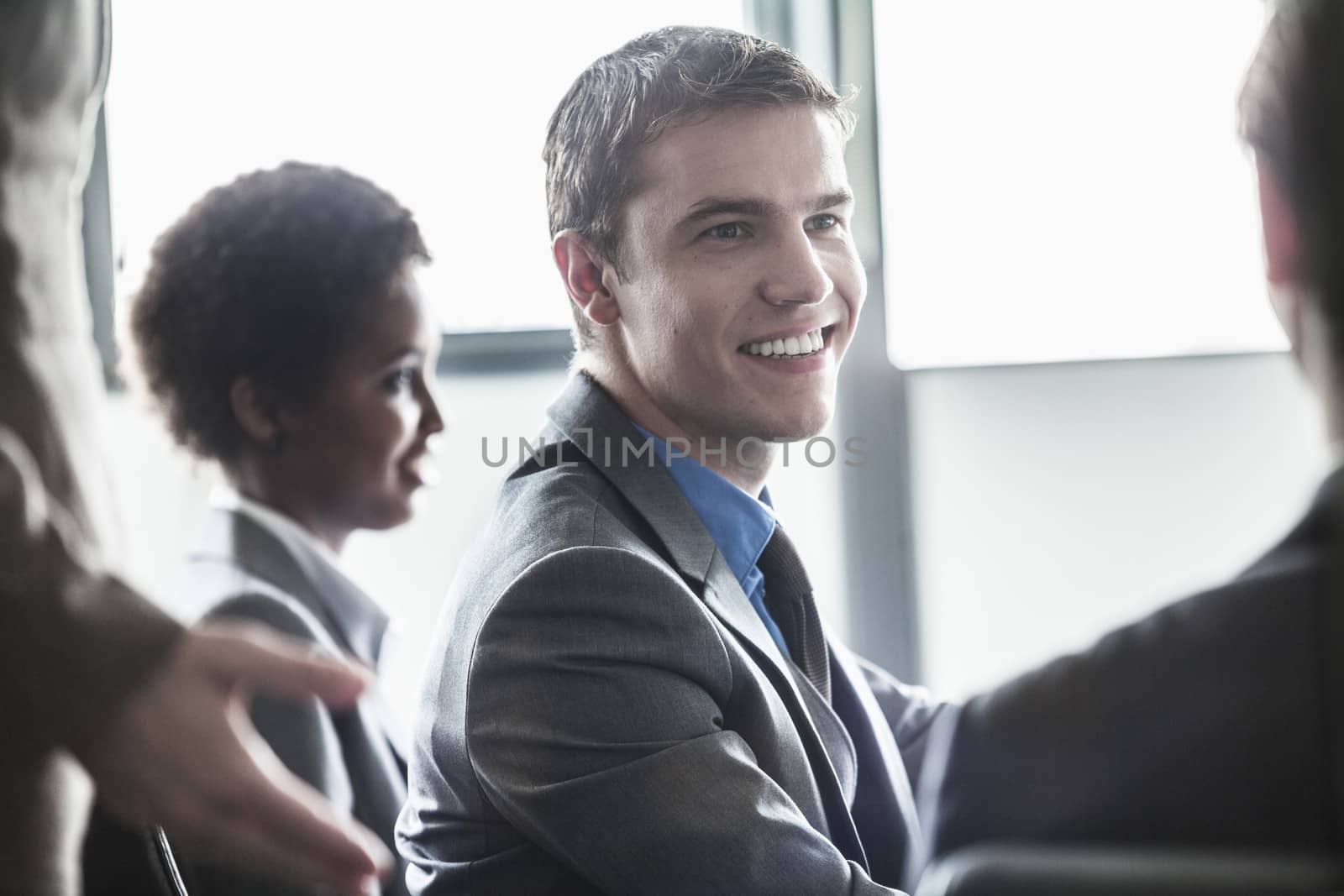 Group of business people sitting and smiling at a business meeting